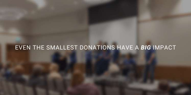 Blurred image from AdvoCon conference with text overlaid that reads, "Event the smallest donations have a big impact."