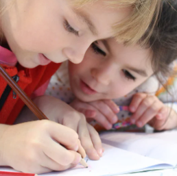 A photo of two young children studying.