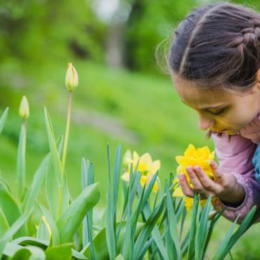 girl smelling spring flower